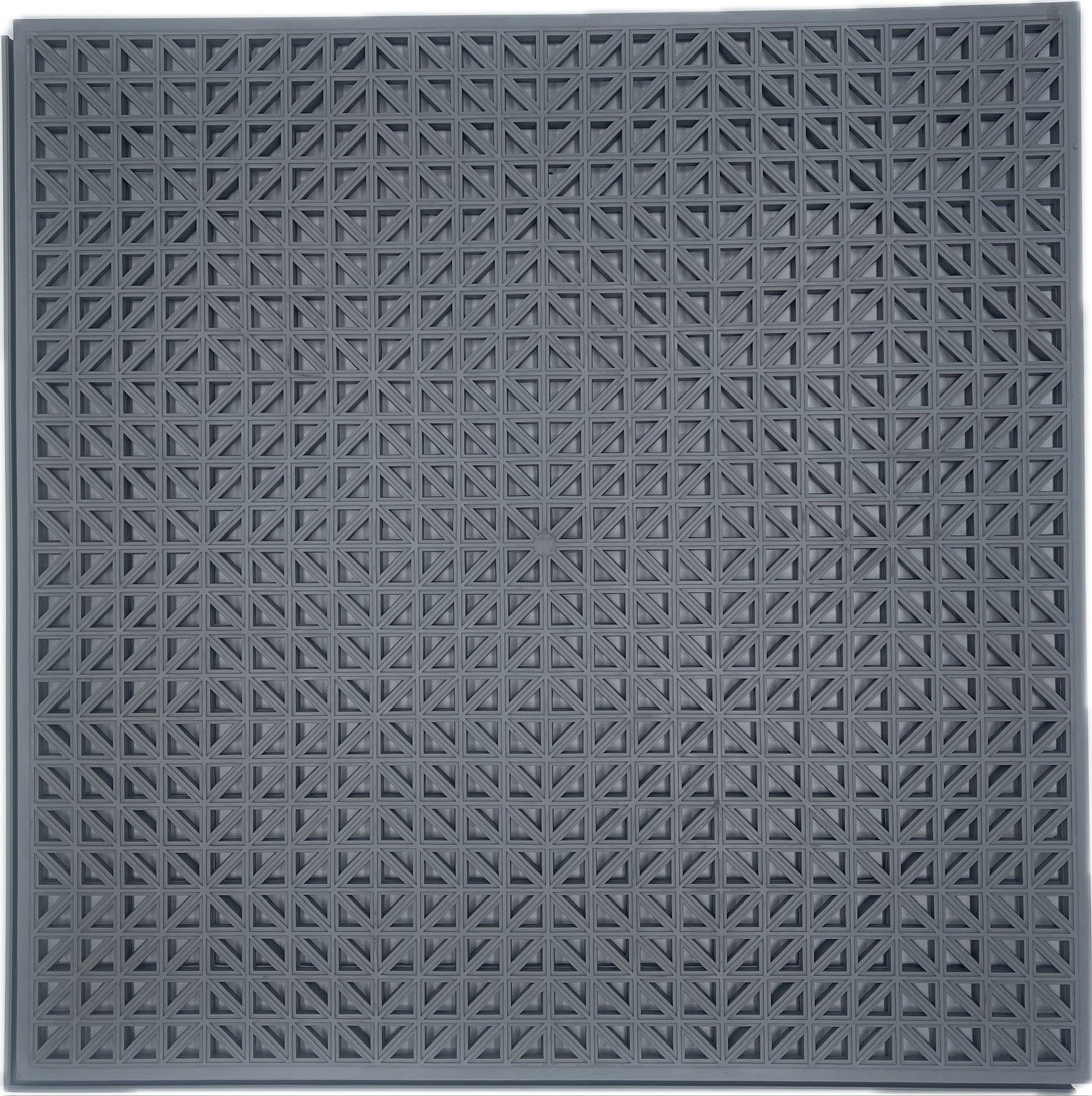 A square dark gray textured flooring mat with a repeating geometric star-like embossed pattern, shown flat against a white background.